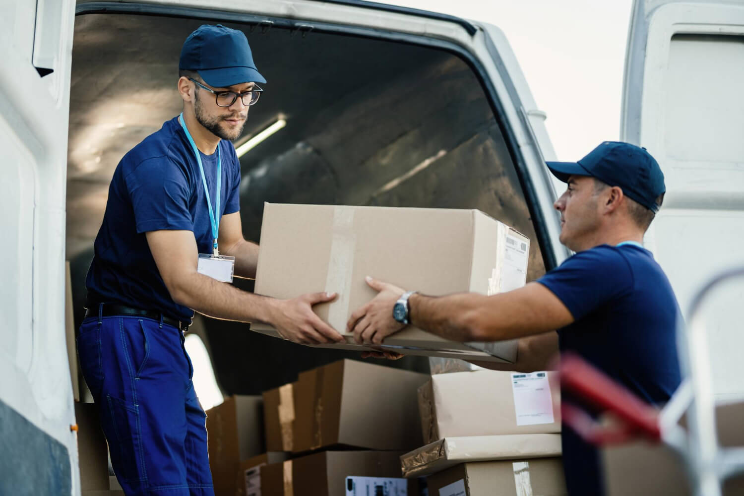 Professional movers loading boxes into a moving van